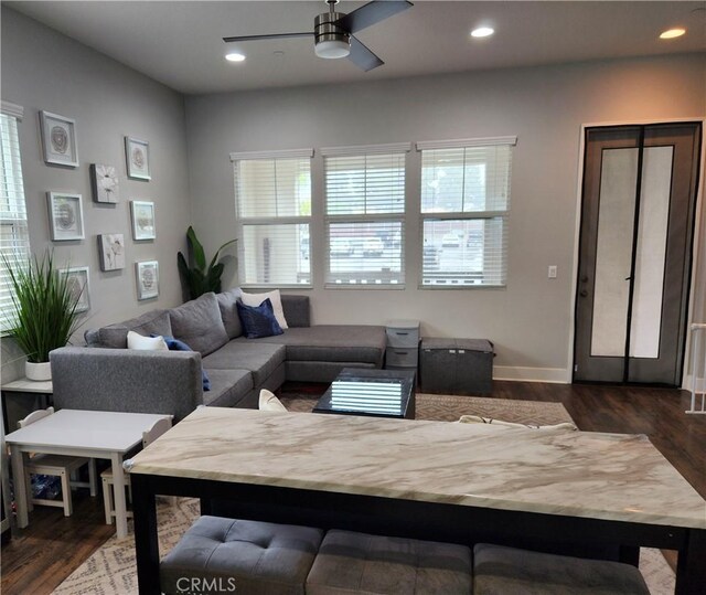 living room featuring dark hardwood / wood-style flooring and ceiling fan