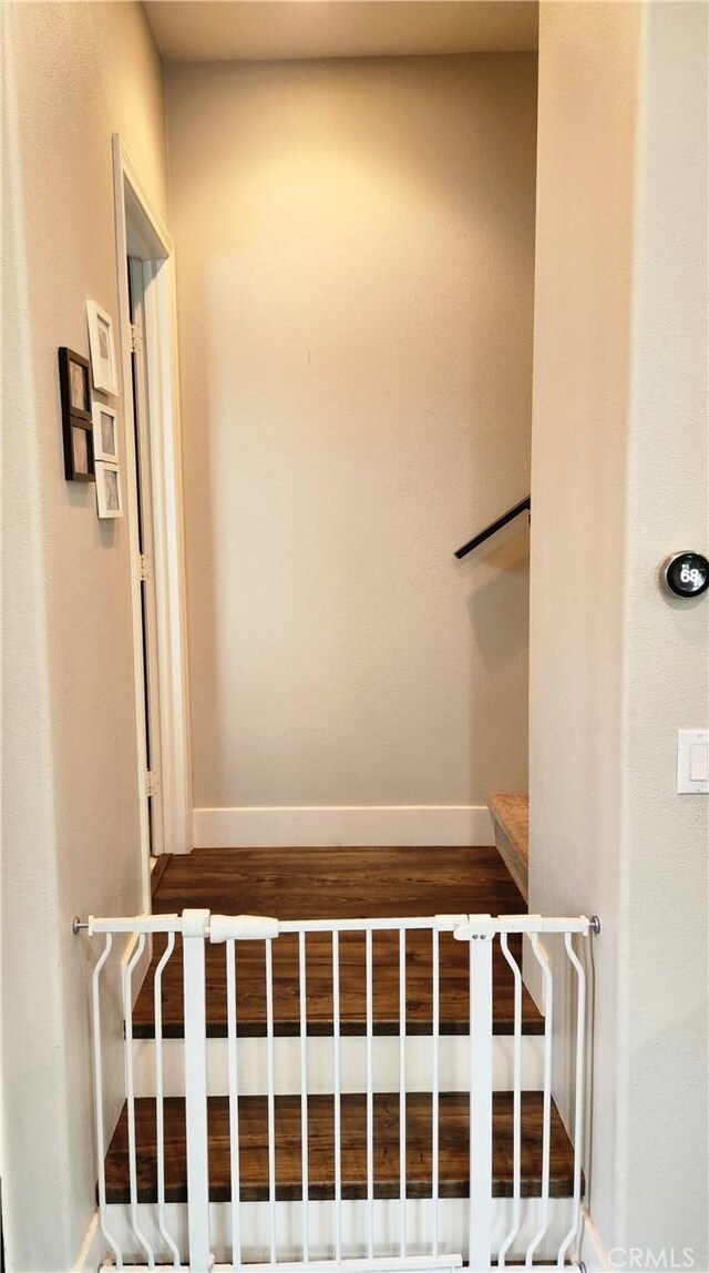 stairs featuring hardwood / wood-style floors