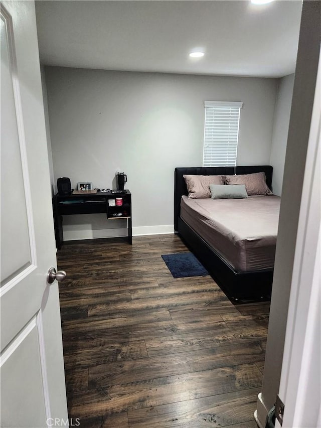 bedroom with dark hardwood / wood-style floors