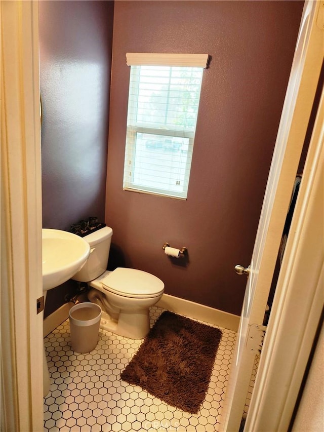 bathroom with sink, tile patterned floors, and toilet