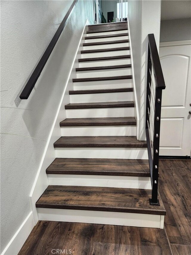 stairway with hardwood / wood-style flooring