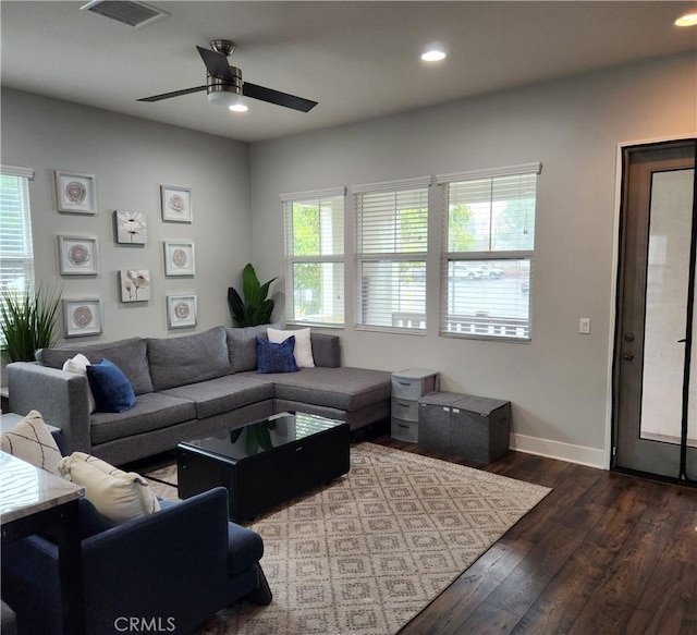 living room with ceiling fan, dark hardwood / wood-style floors, and a wealth of natural light