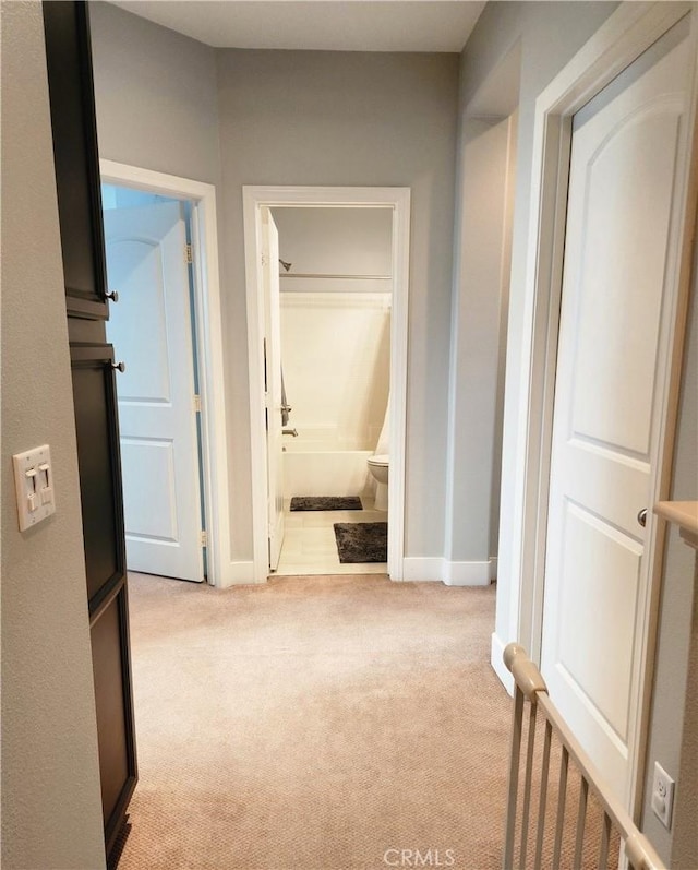 hallway with light colored carpet