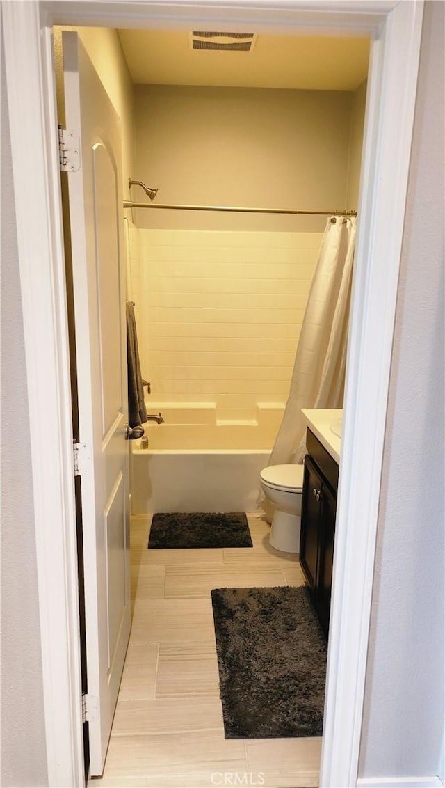 full bathroom with vanity, toilet, and shower / bath combo with shower curtain