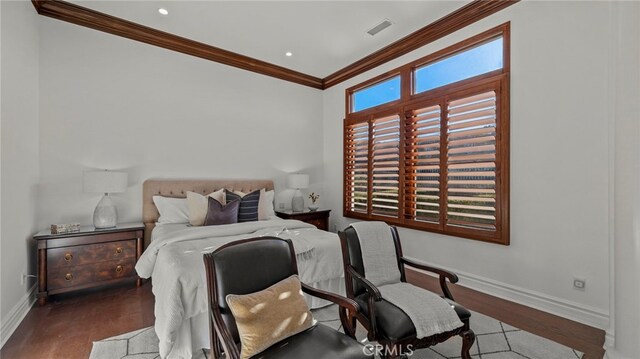 bedroom featuring hardwood / wood-style flooring and crown molding