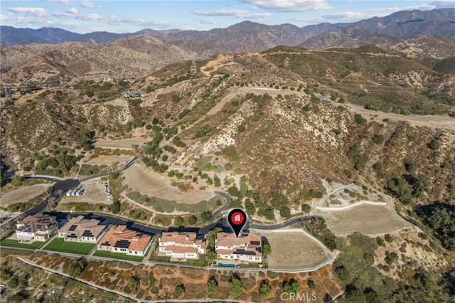 birds eye view of property featuring a mountain view