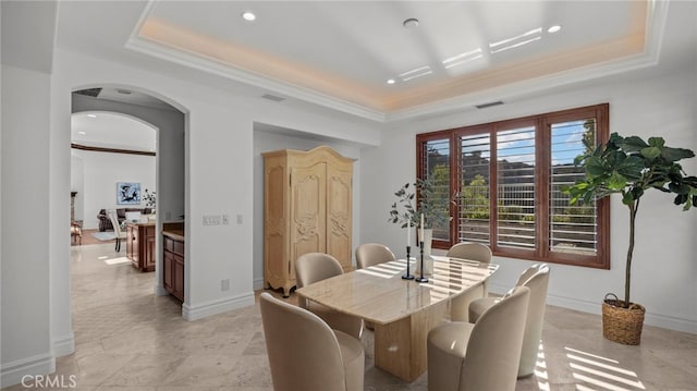 dining room with crown molding and a tray ceiling