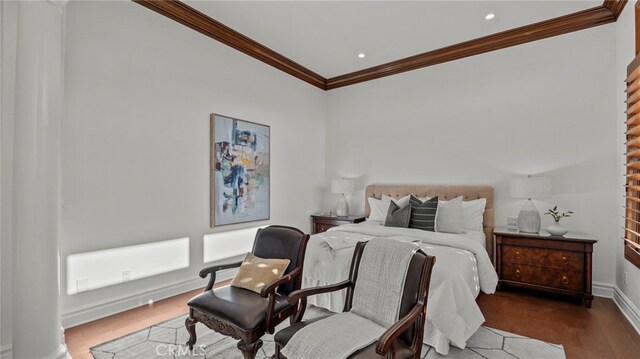 bedroom with dark wood-type flooring and ornamental molding