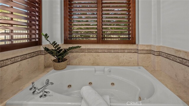 bathroom with tiled tub