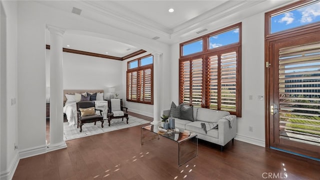 interior space with ornate columns, crown molding, and dark hardwood / wood-style flooring