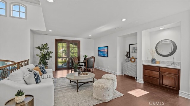 living room with sink and dark hardwood / wood-style floors