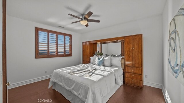 bedroom featuring dark hardwood / wood-style flooring and ceiling fan