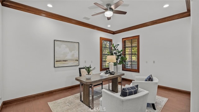 home office featuring hardwood / wood-style floors, ornamental molding, and ceiling fan