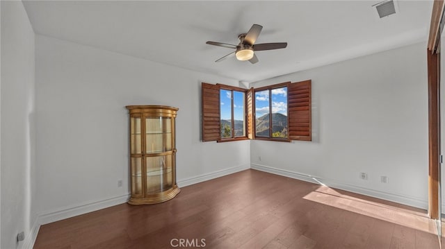 spare room with hardwood / wood-style floors and ceiling fan