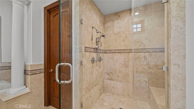 bathroom with ornate columns and an enclosed shower