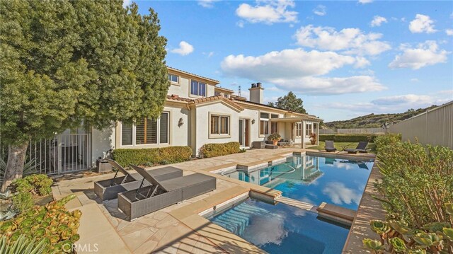 view of pool with a patio and an in ground hot tub