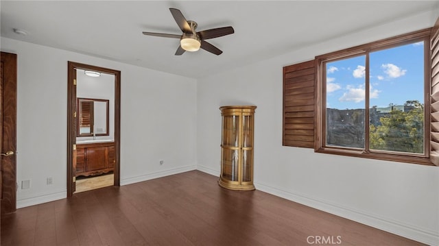 unfurnished room with ceiling fan and dark hardwood / wood-style flooring