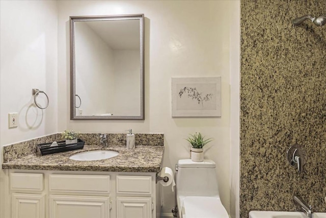 bathroom featuring vanity and toilet