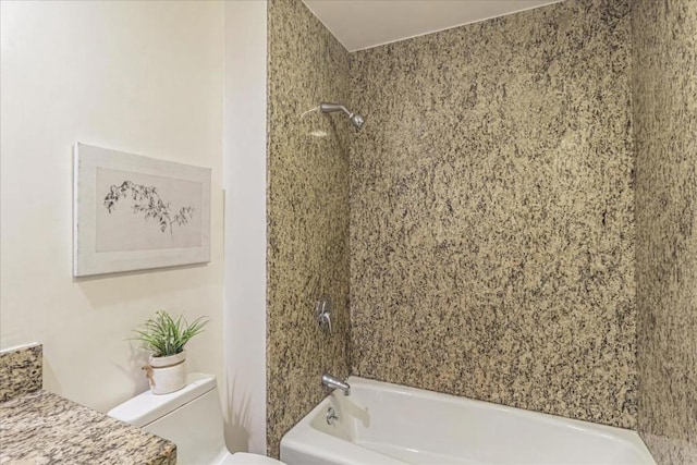 bathroom featuring tiled shower / bath combo and toilet