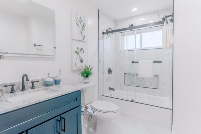 full bathroom featuring vanity, shower / bath combination with glass door, and toilet