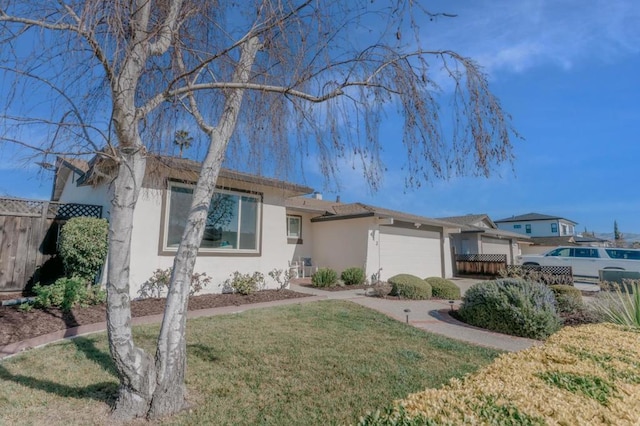 view of front of house featuring a garage and a front lawn