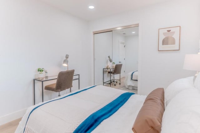 bedroom with a closet and light hardwood / wood-style flooring