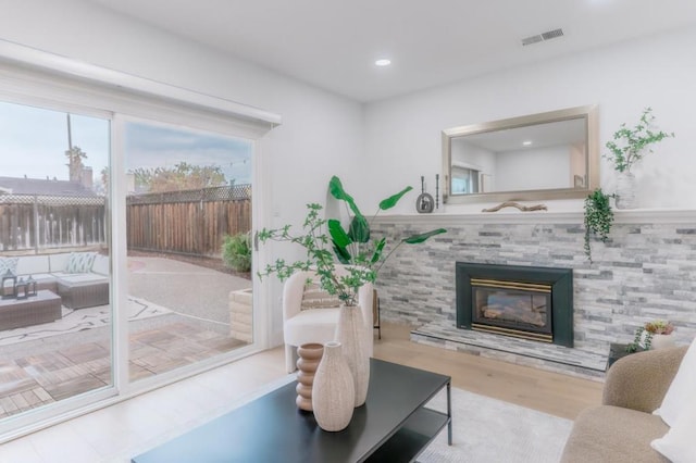 living room with a fireplace and light hardwood / wood-style flooring