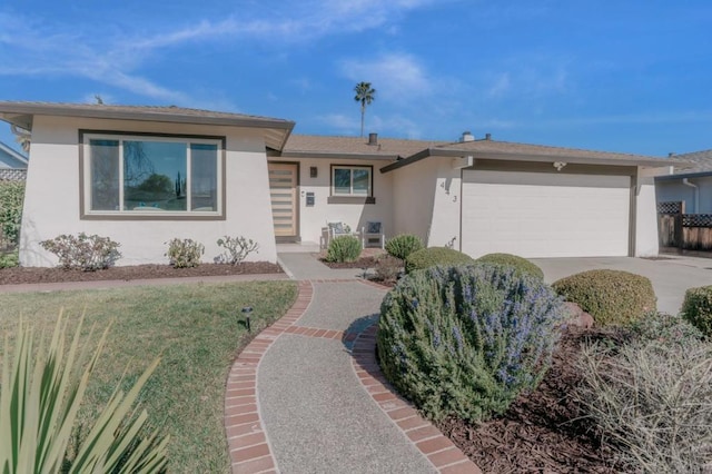 ranch-style home featuring a garage and a front lawn