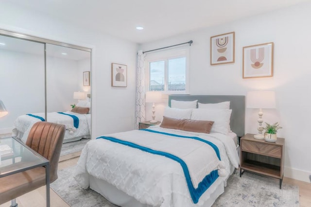 bedroom featuring light hardwood / wood-style flooring and a closet