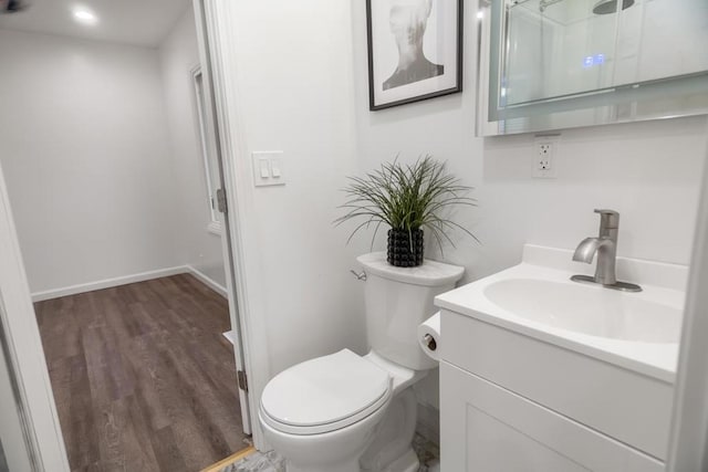 bathroom with hardwood / wood-style flooring, vanity, and toilet