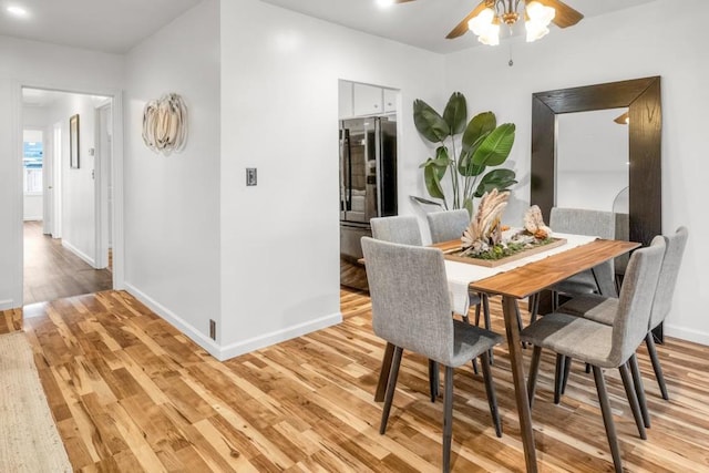 dining room featuring ceiling fan and light hardwood / wood-style flooring