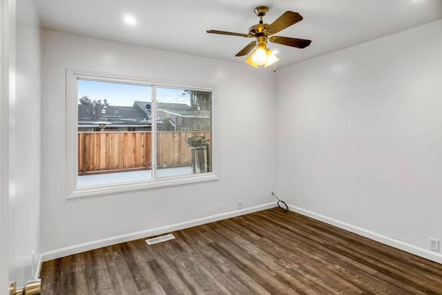 spare room featuring ceiling fan and dark hardwood / wood-style flooring