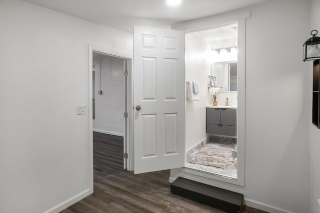 corridor featuring dark hardwood / wood-style flooring and sink