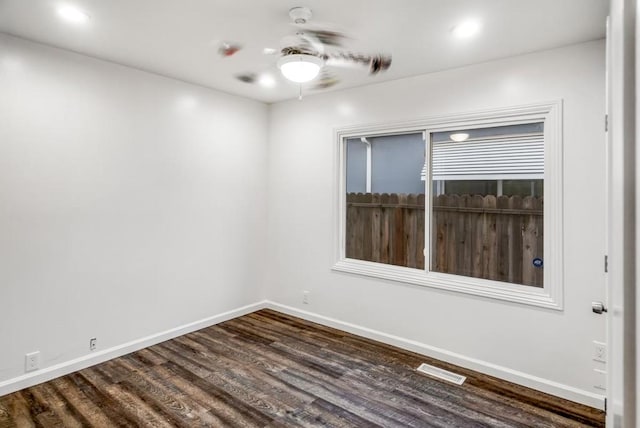 unfurnished room featuring dark hardwood / wood-style flooring and ceiling fan