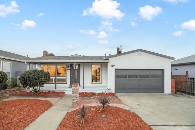 ranch-style home featuring a garage and covered porch