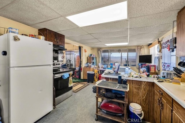 kitchen featuring white refrigerator, ventilation hood, electric stove, and a drop ceiling