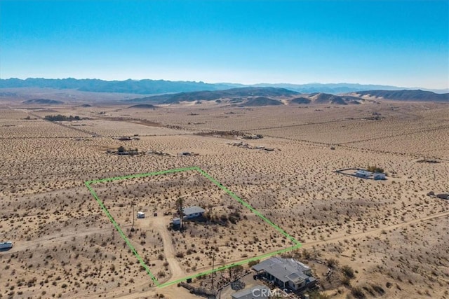 birds eye view of property with a mountain view