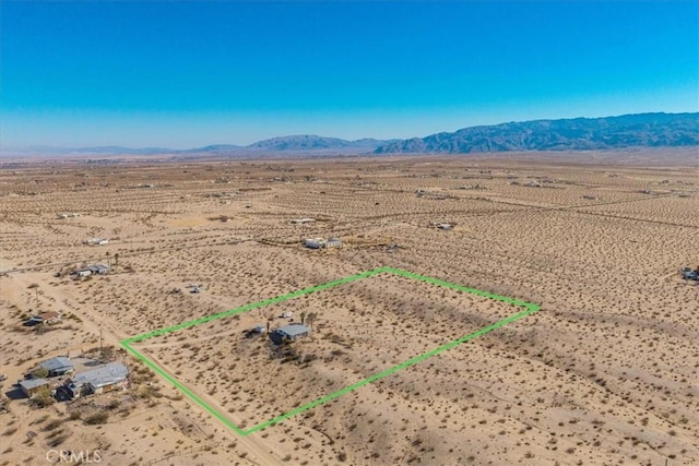 birds eye view of property featuring a mountain view