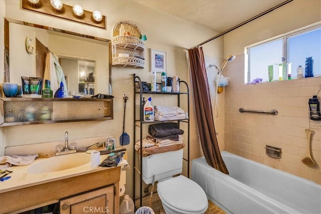 full bathroom featuring vanity, shower / bath combo with shower curtain, and toilet