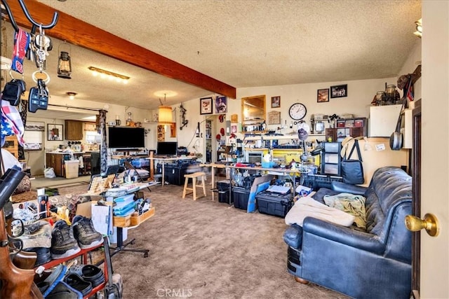 interior space with a textured ceiling, a workshop area, beamed ceiling, and carpet