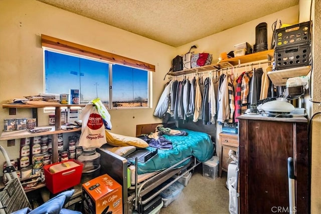 carpeted bedroom featuring a textured ceiling