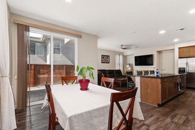 dining room featuring dark wood finished floors, visible vents, and recessed lighting