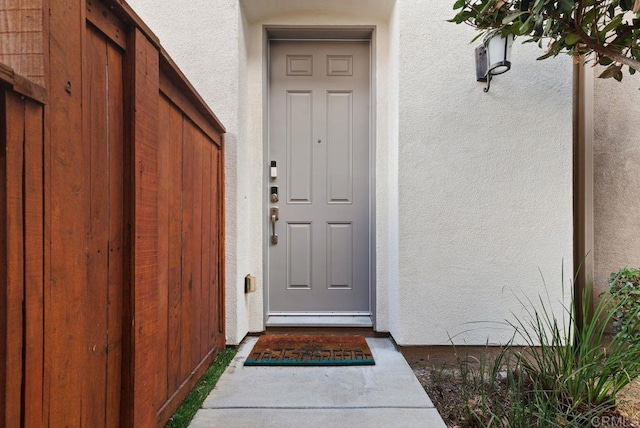 property entrance with stucco siding