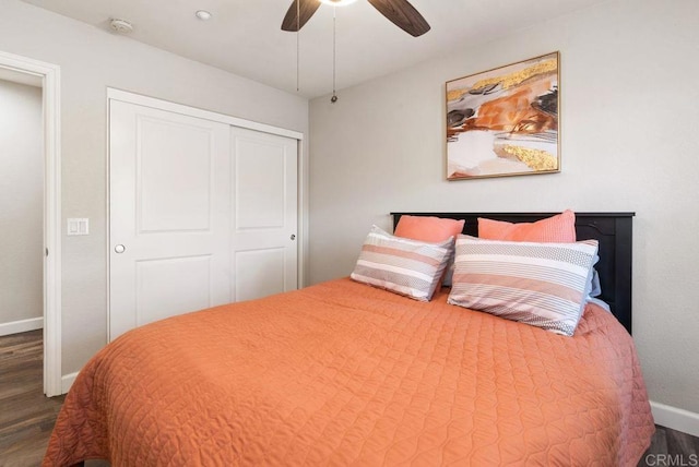 bedroom with a closet, baseboards, ceiling fan, and dark wood-style flooring