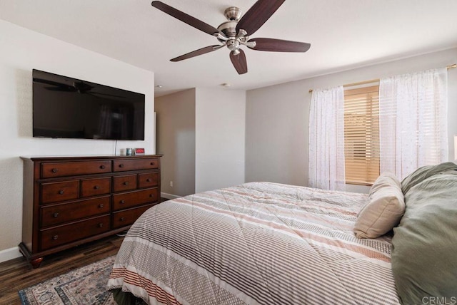 bedroom featuring dark wood-style flooring, ceiling fan, and baseboards