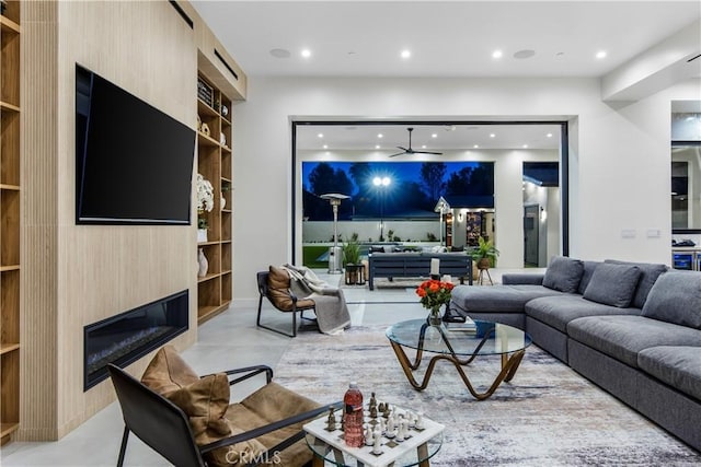 living room featuring built in shelves and a fireplace