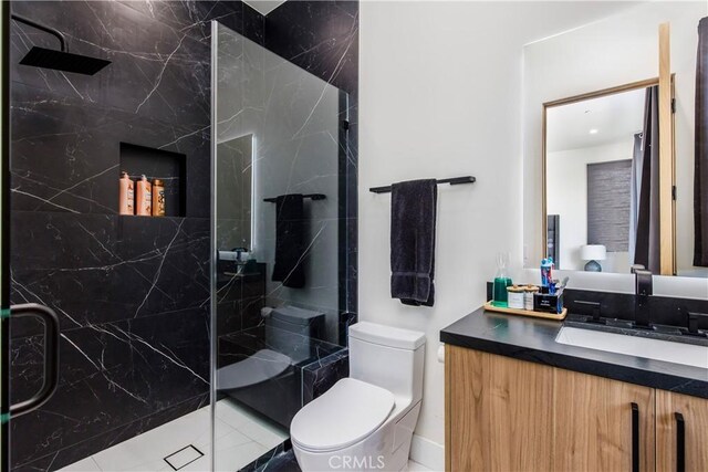 bathroom with vanity, toilet, and a shower with shower door