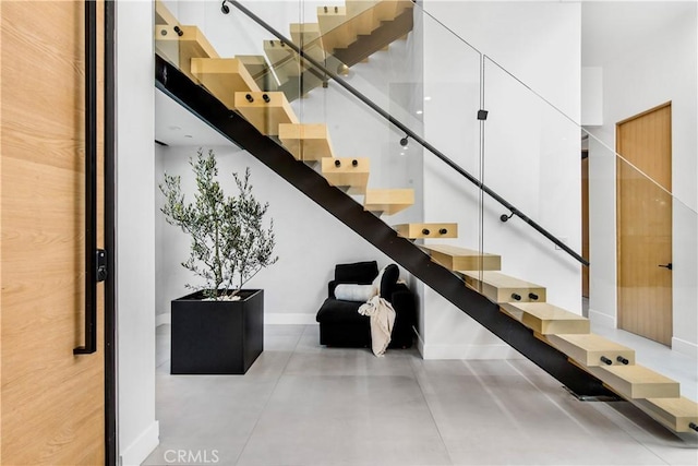 stairs featuring concrete floors