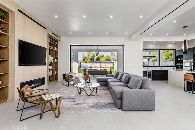 living room with a wealth of natural light, a fireplace, and built in features