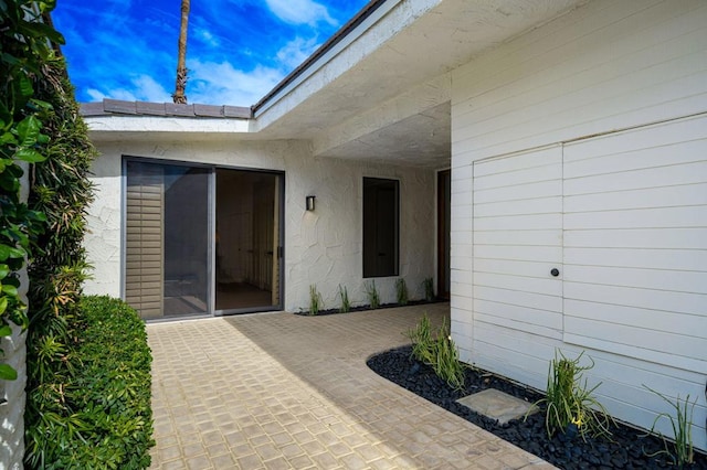 entrance to property featuring a patio